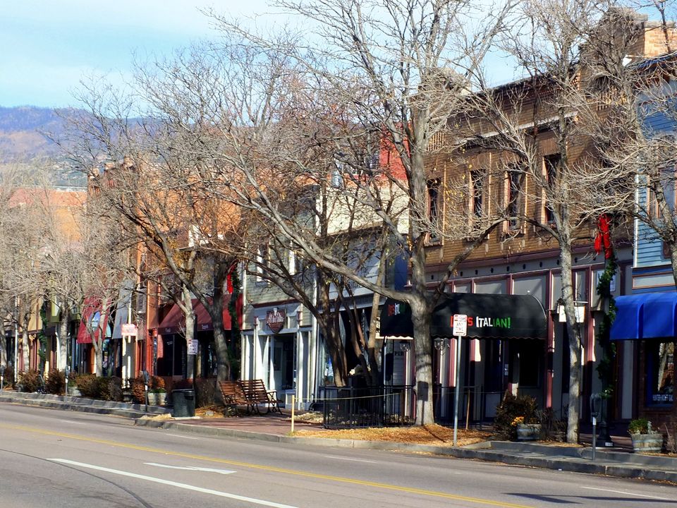 Storefronts and bare cottonwoods along West Colorado Avenue in Old Colorado City