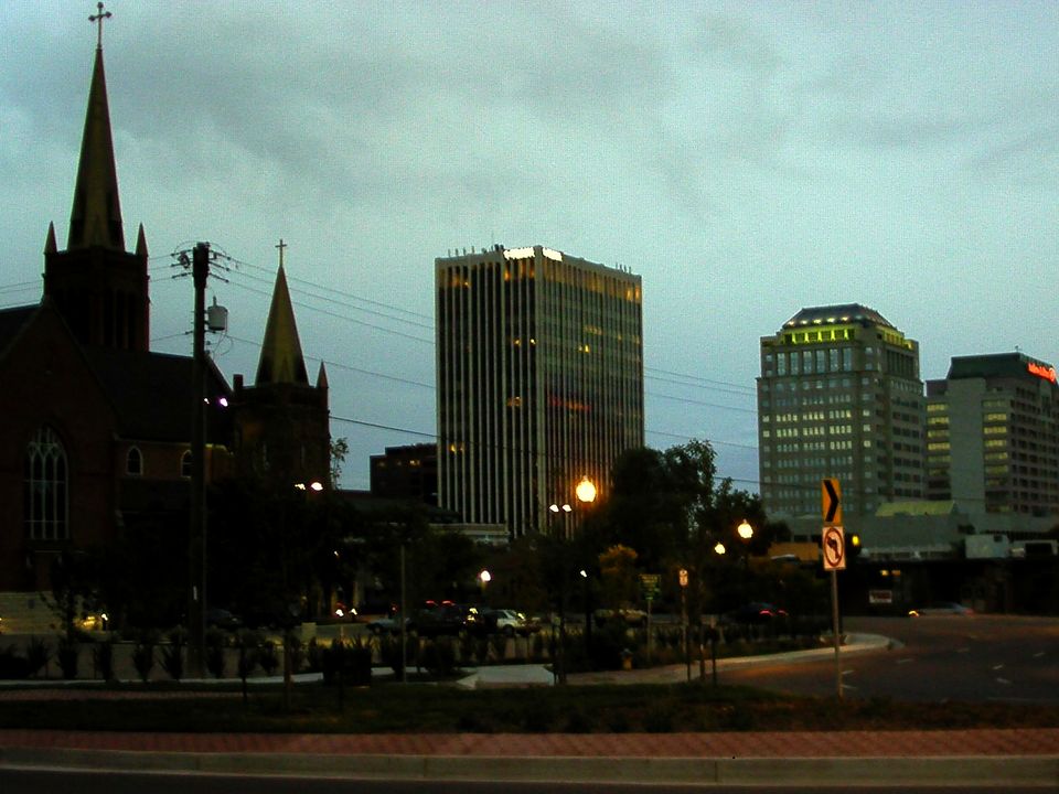 Downtown Colorado Springs at dusk, with church spires and office towers lit up