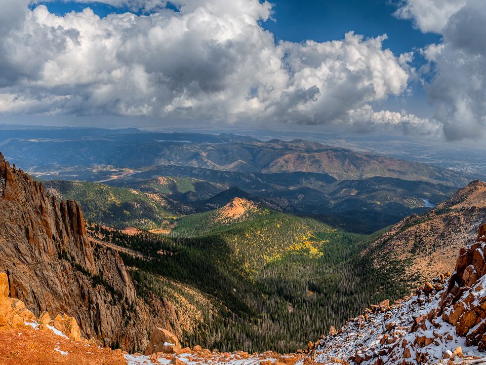 View down the Pikes Peak Highway over red granite and forested valleys