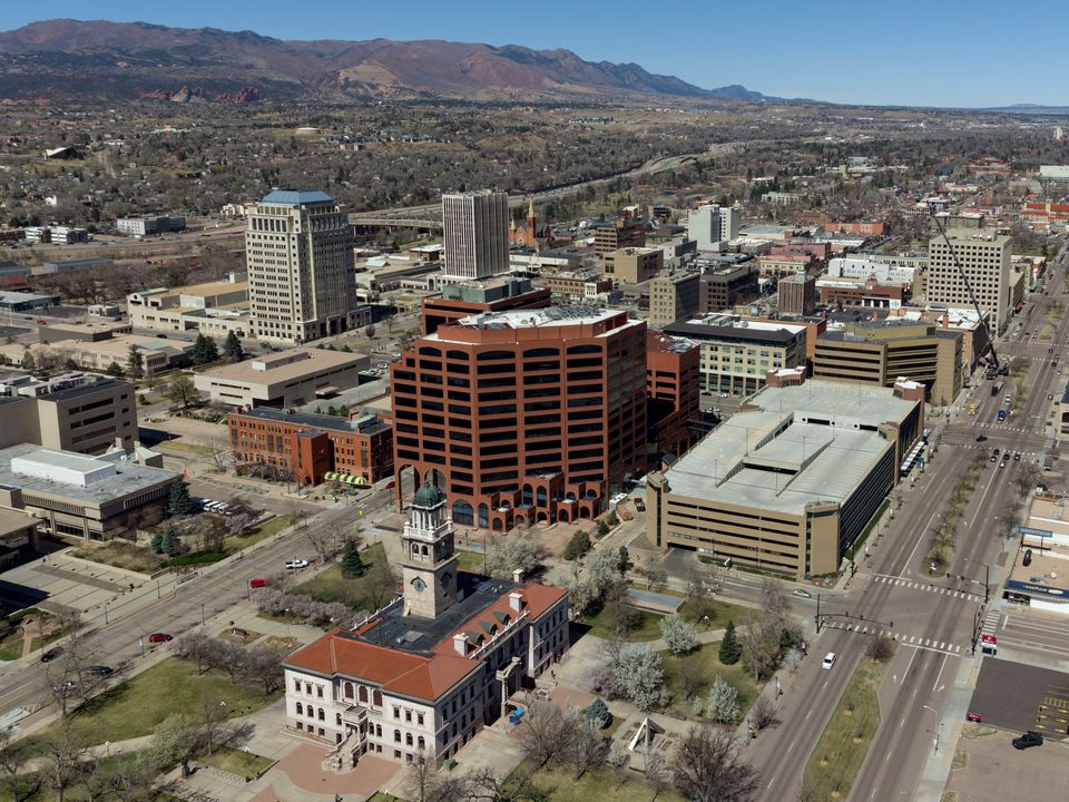 Downtown Colorado Springs from above, with the mountains on the horizon